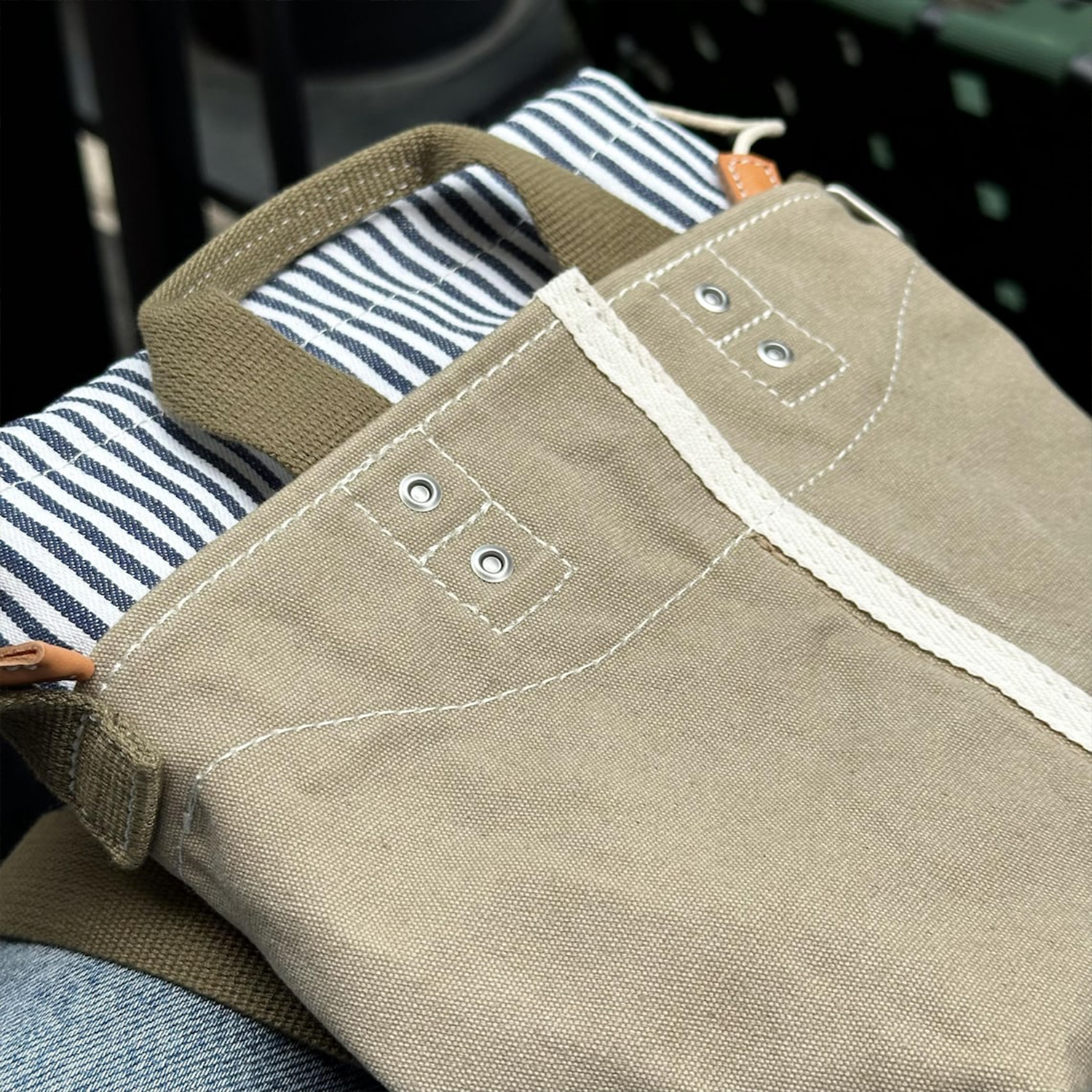 Muted Khaki Woven Mini Bucket Pouch With White Contrast Stitching, Drawstring Striped Liner And Woven Top Hand Loops