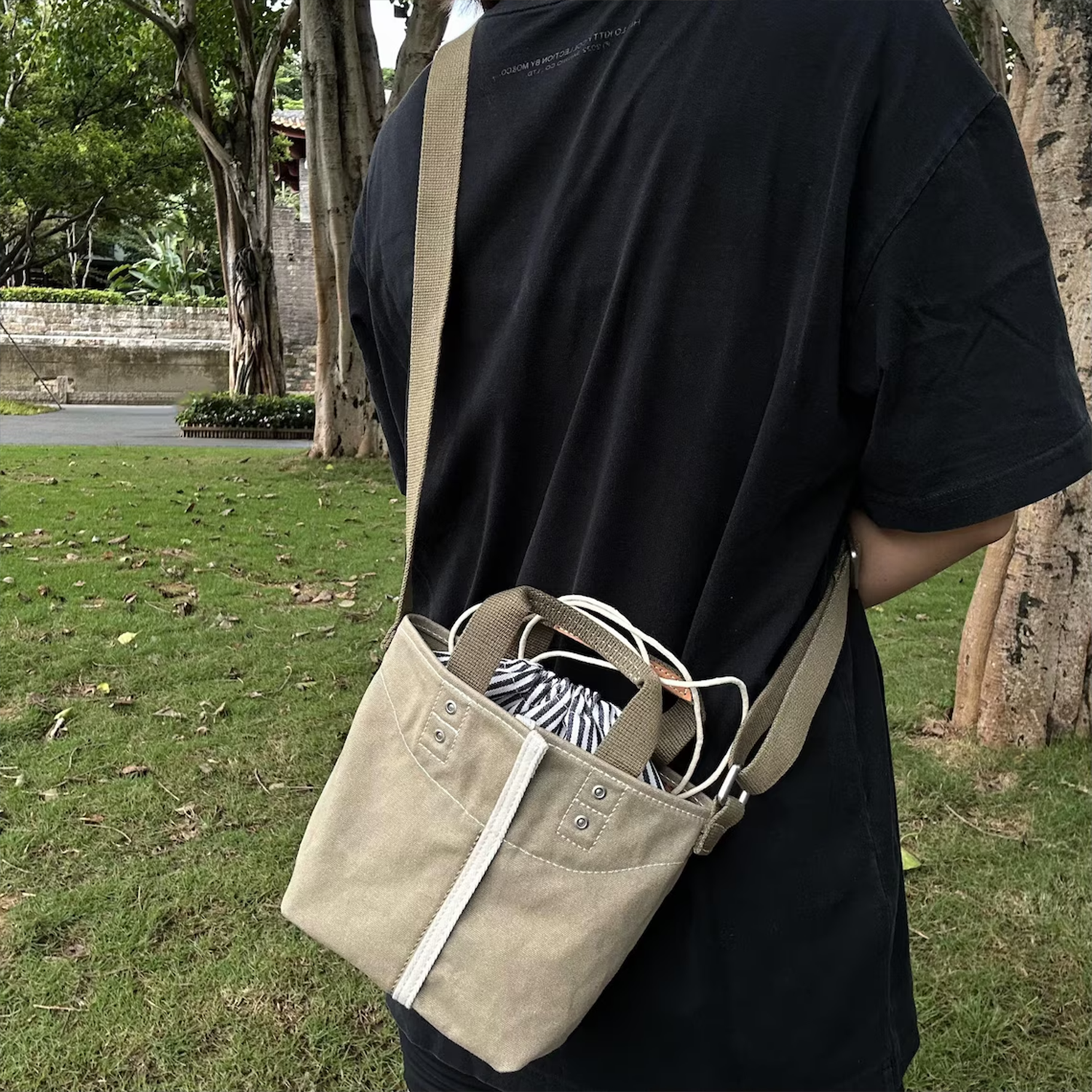 Muted Khaki Woven Mini Bucket Pouch With White Contrast Stitching, Drawstring Striped Liner And Woven Top Hand Loops